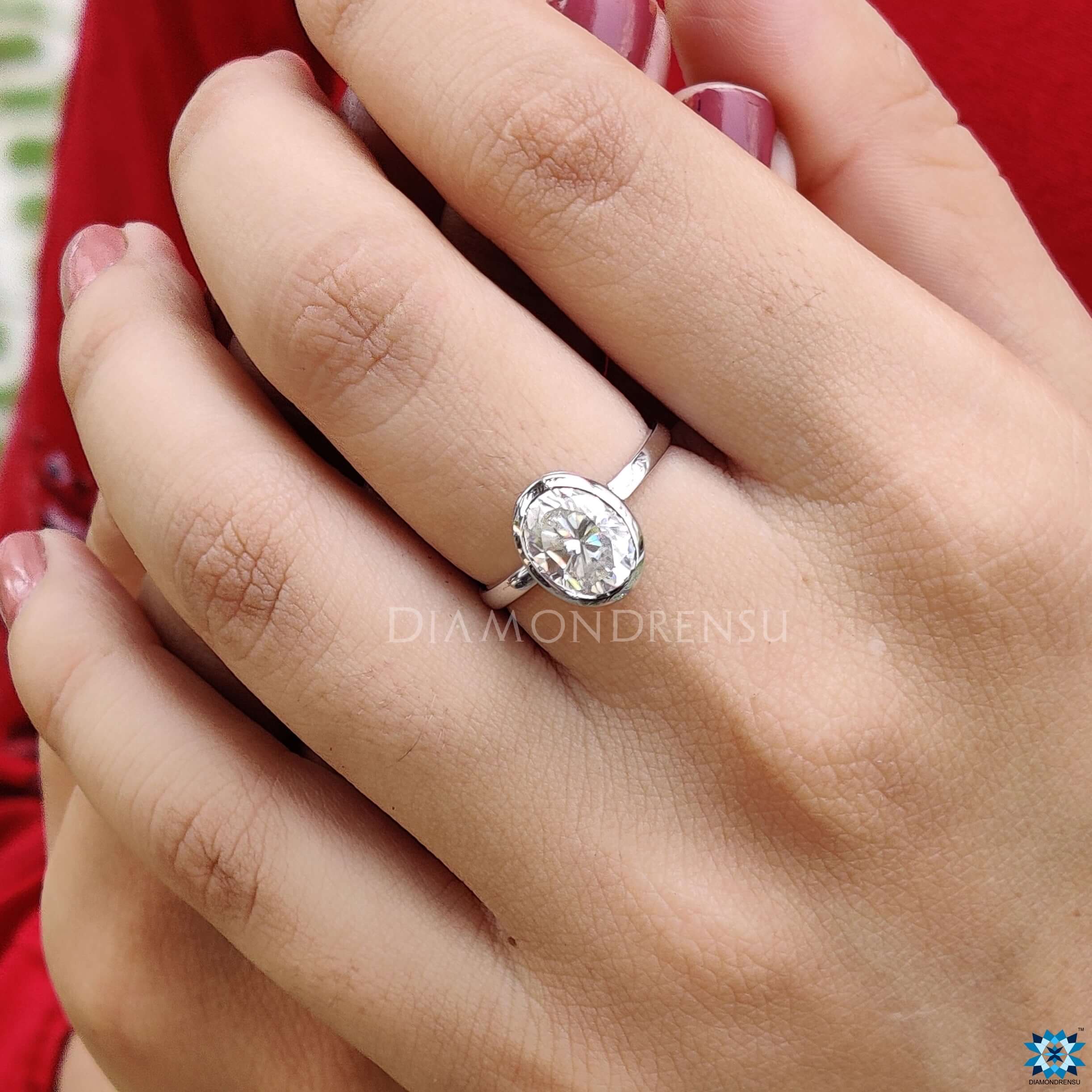 Buy Engagement Ring with a stunning oval moissanite centrepiece.