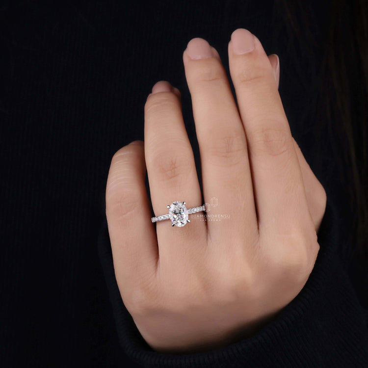 Pave setting showcasing the brilliance of the oval diamond and handcrafted for precision.

