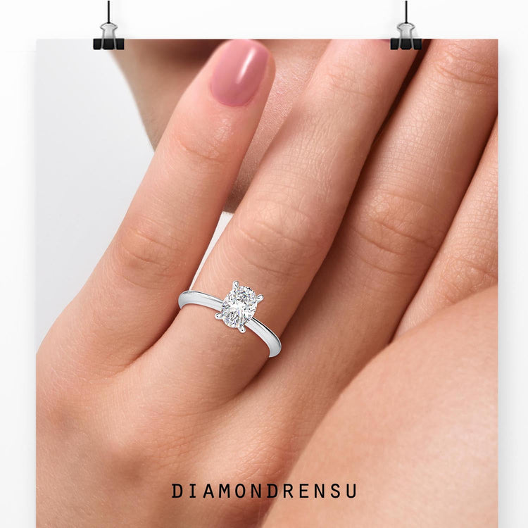 Yellow gold oval diamond ring with tapered shank band.
