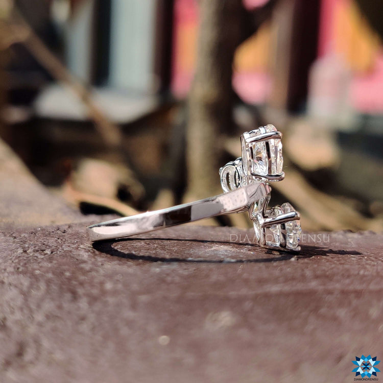 White gold engagement ring with three moissanite stones.
