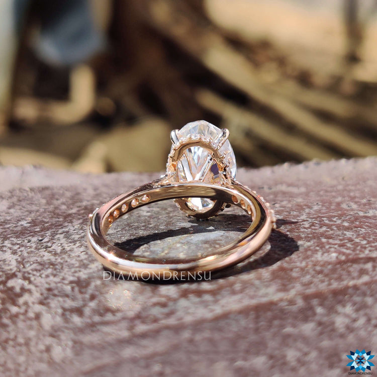 Rose gold moissanite ring with 4 prong claw setting.
