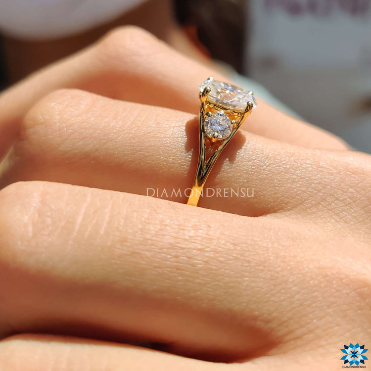 Oval cut moissanite ring with round side stones.
