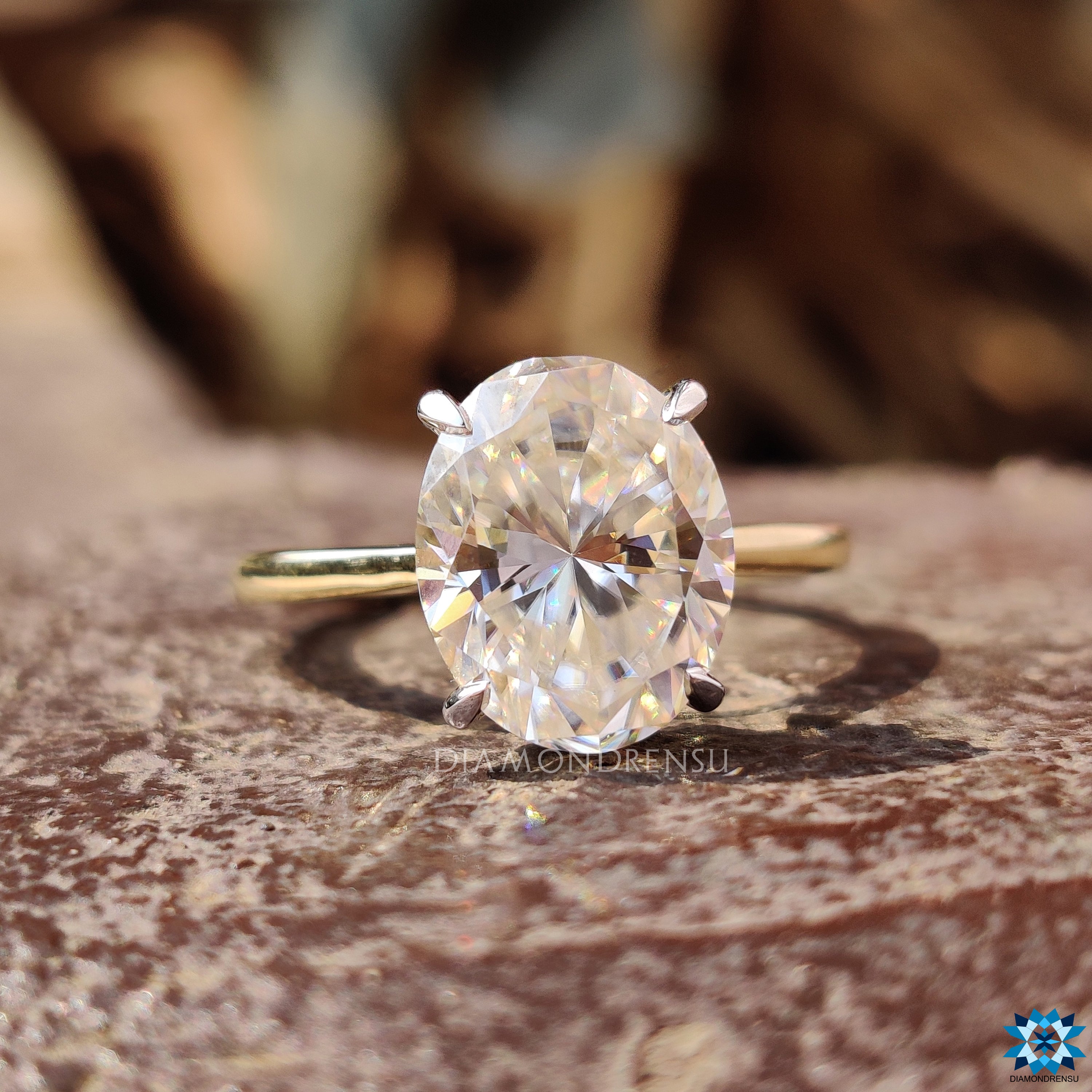 Hidden halo round cut moissanite ring in two-tone gold finish.
