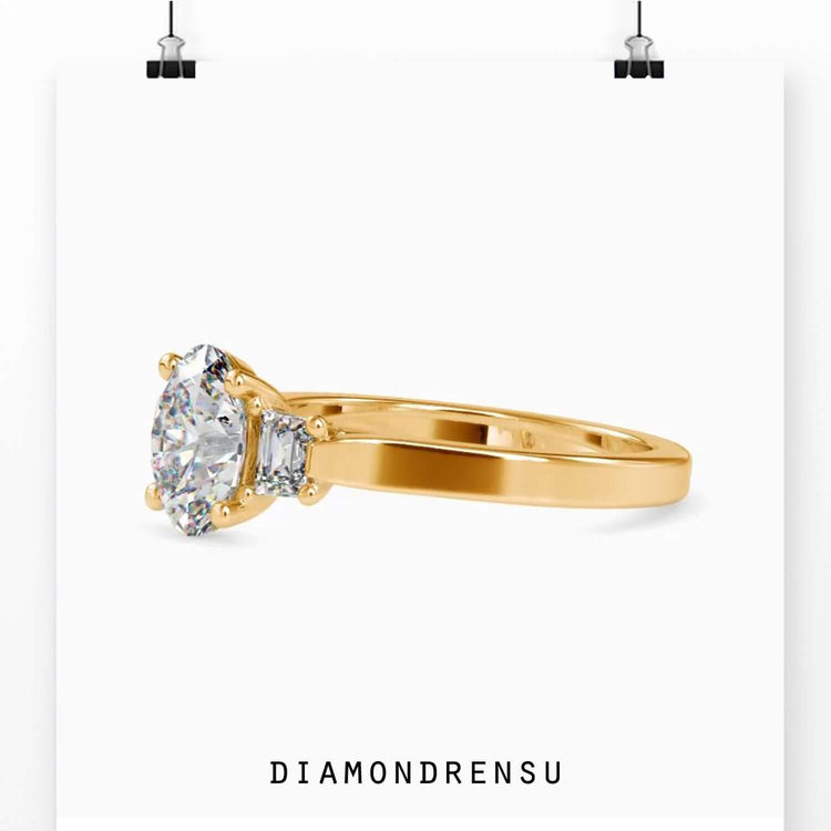 UK diamond ring with trapezium side stones and oval centre.
