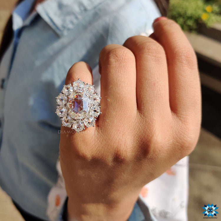 Oval rose cut ring crafted in a white gold cluster halo setting.
