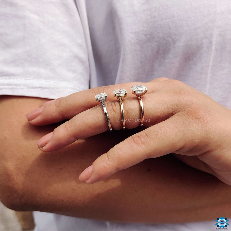 Rose gold moissanite ring with oval center stone.
