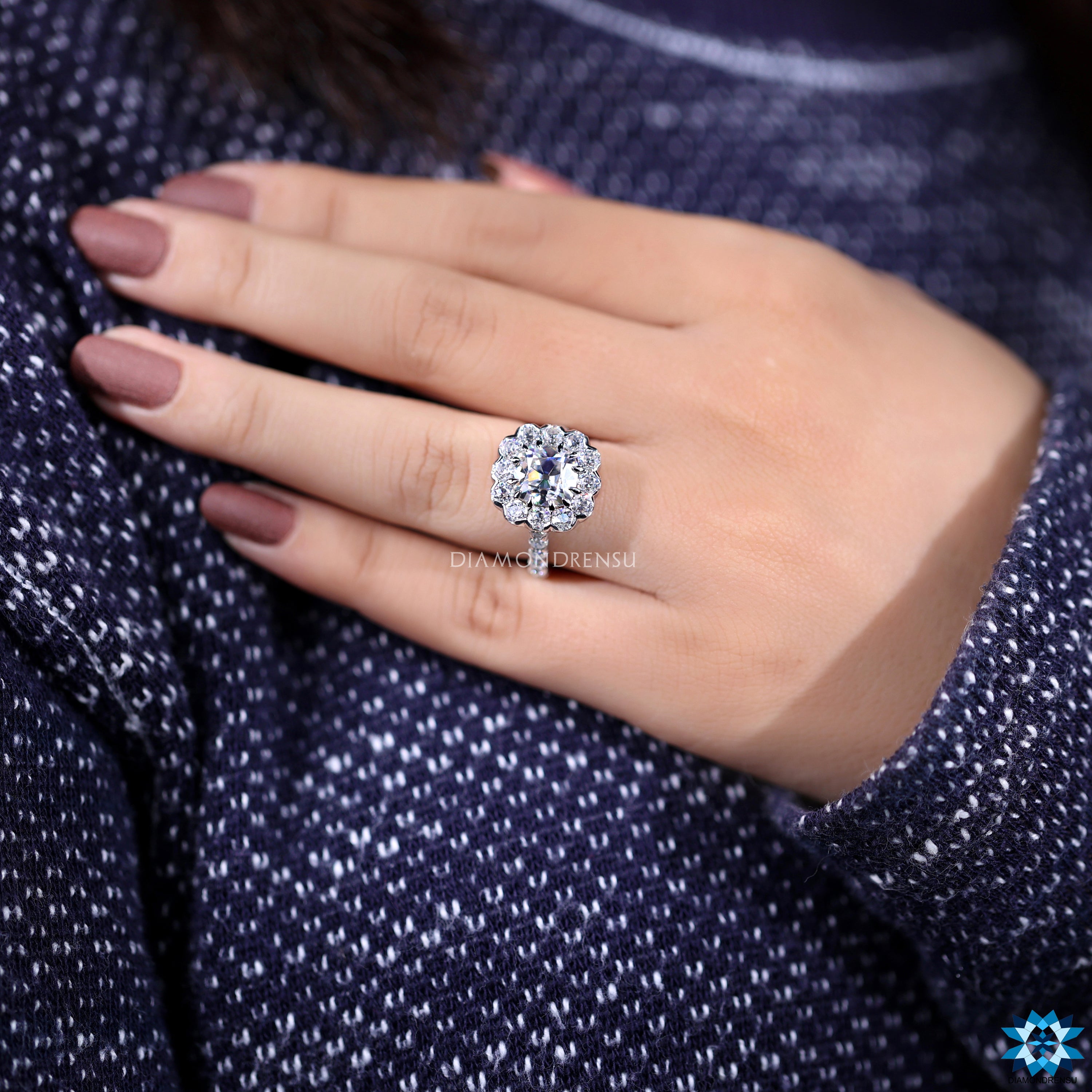 Custom engagement ring with cushion moissanite and pave round cut band.
