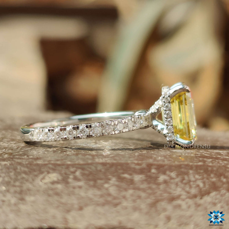 Hidden halo ring with emerald cut canary moissanite and pave band.
