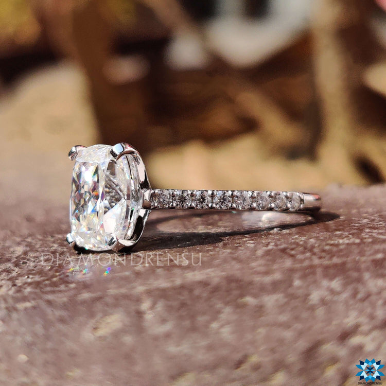 Cushion cut moissanite ring with cathedral and pave setting.
