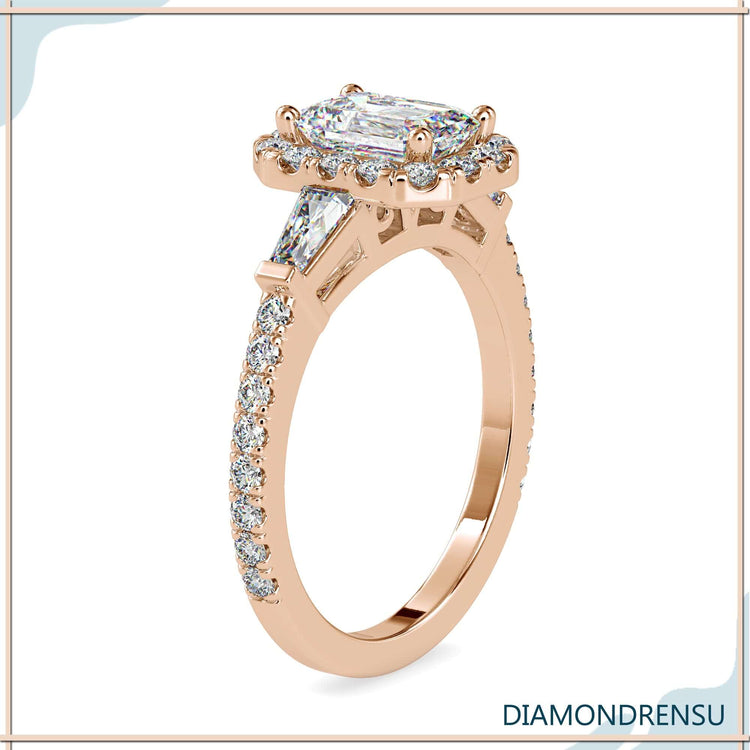 Emerald cut diamond with round halo and pave band.
