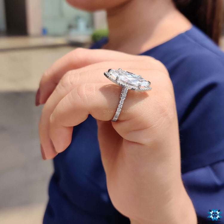 Marquise cut moissanite surrounded by halo setting.
