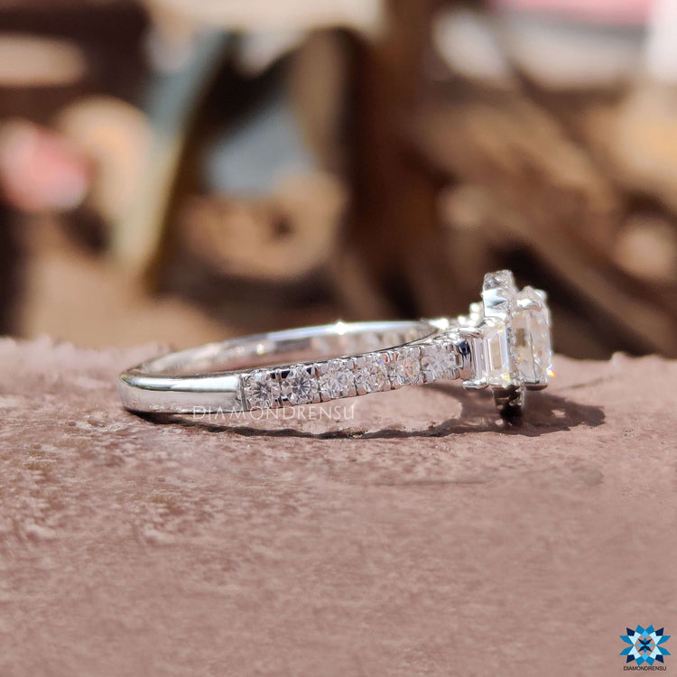 Moissanite engagement ring with filigree style and round pave halo.
