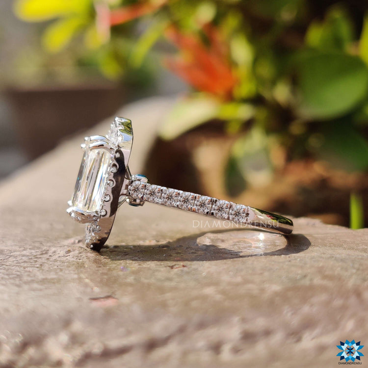 Vintage-inspired halo ring featuring blue round cut moissanite.
