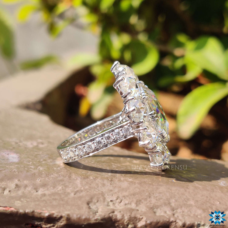 Round rose cut halo setting with fishtail prong in white gold.
