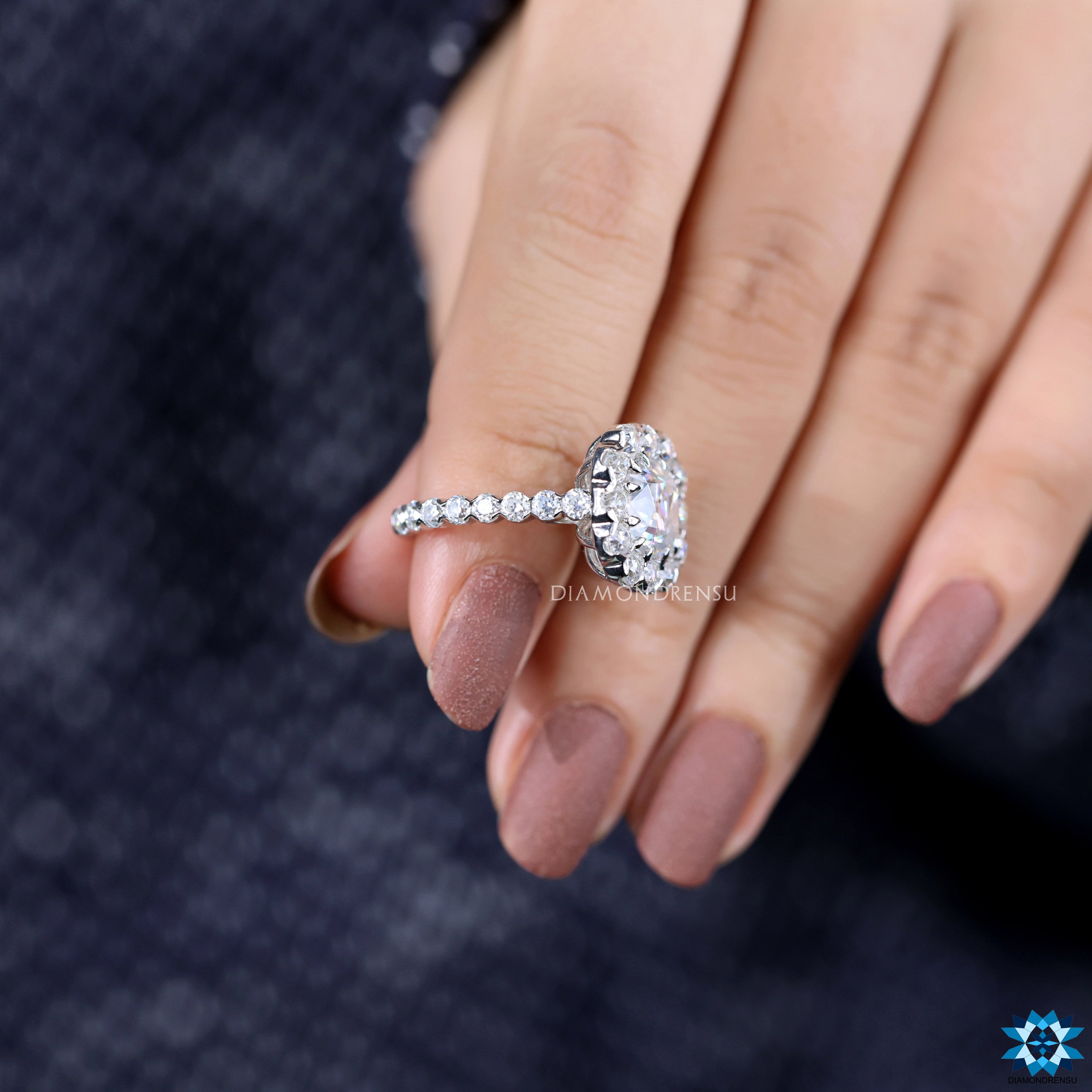 Round cut pave band with halo setting and old mine cushion moissanite.
