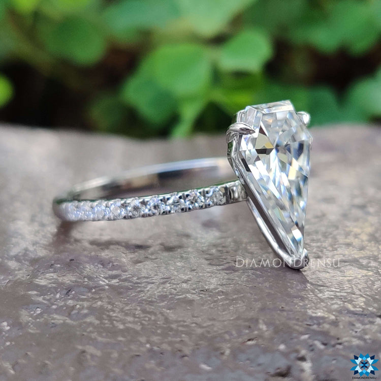 Handmade spear cut moissanite ring with pave band.

