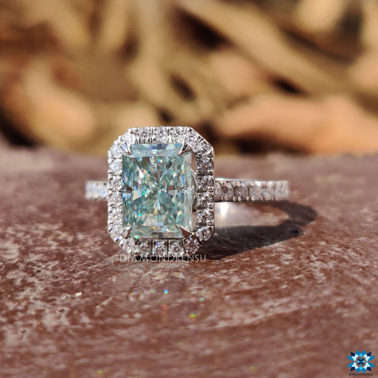 Radiant engagement ring in white gold with a four claw prong setting.
