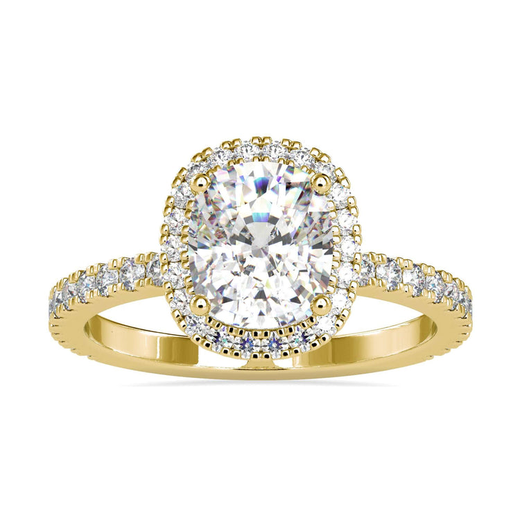 Cushion engagement ring with halo in yellow gold.
