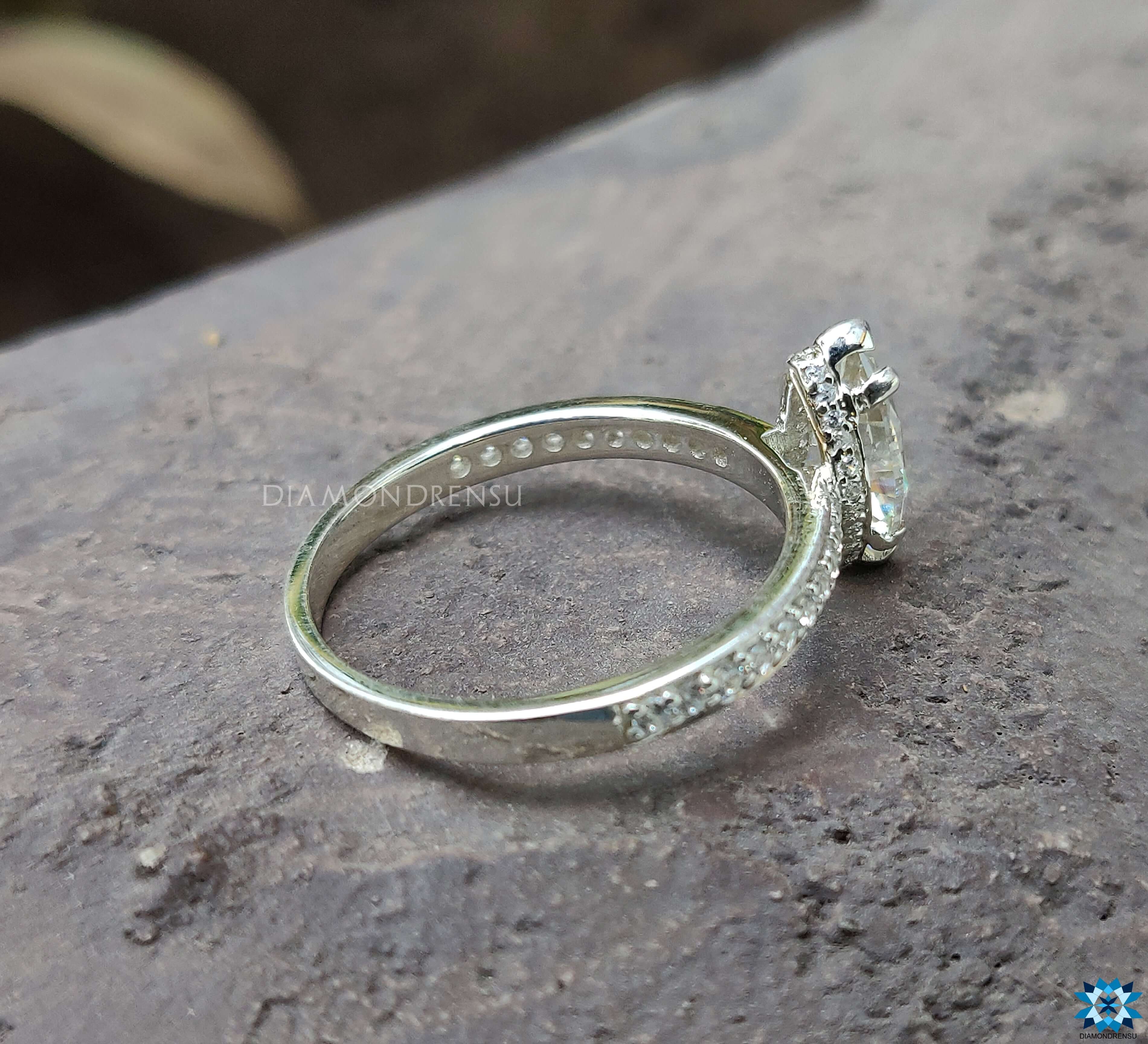 White gold ring with a marquise Moissanite centre and prong setting ring.