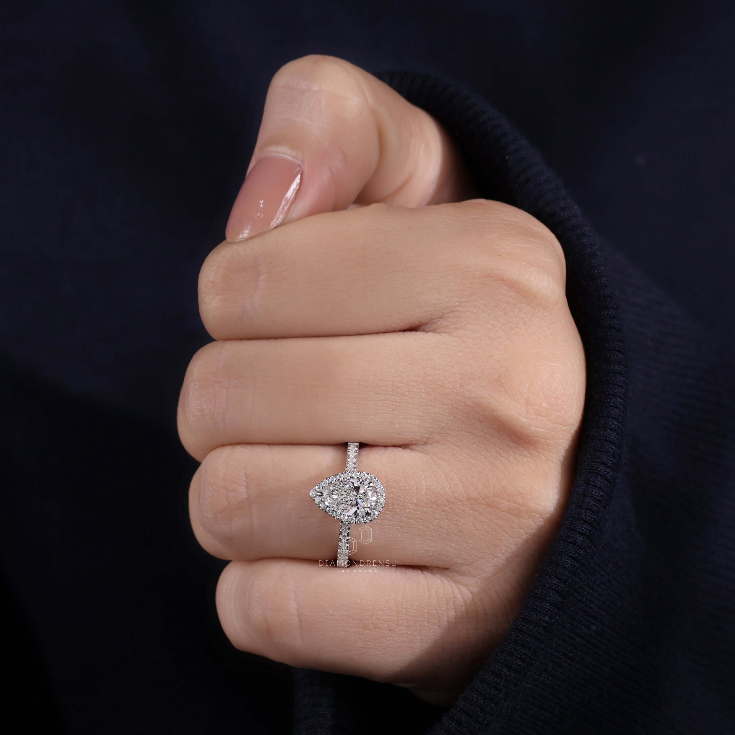 Pear shaped halo engagement ring with exquisite details.