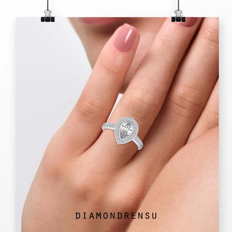 Rose gold engagement ring with pear shaped diamond centre.
