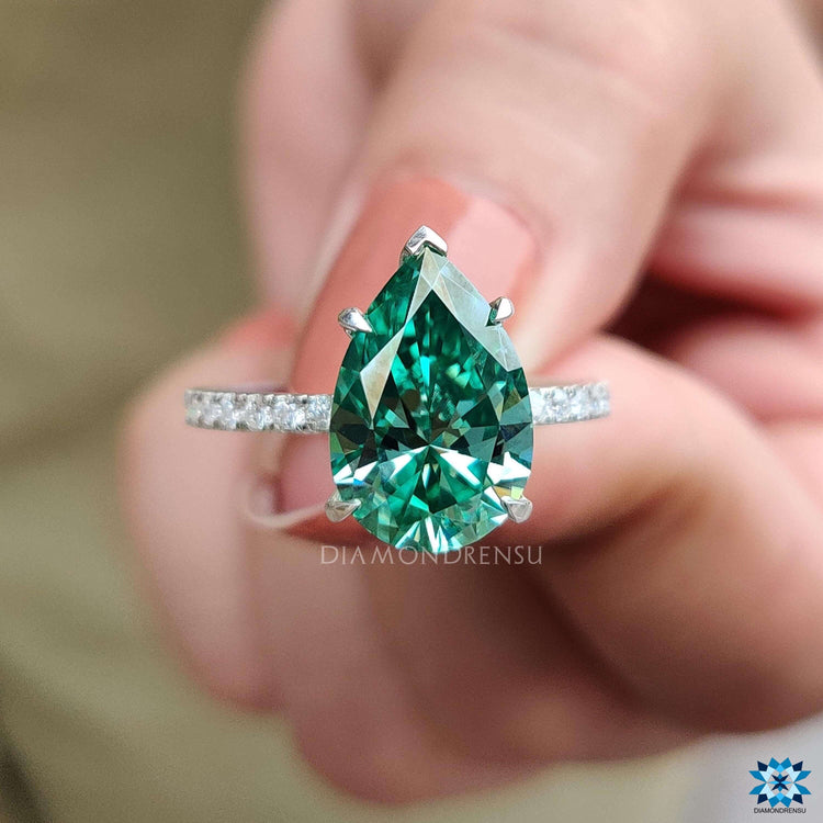 White gold moissanite ring with pear shaped stone.
