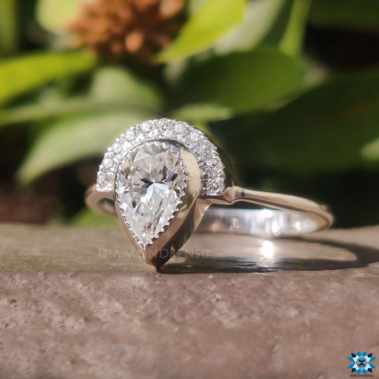 Round cut moissanite set in a beautiful vintage engagement ring.