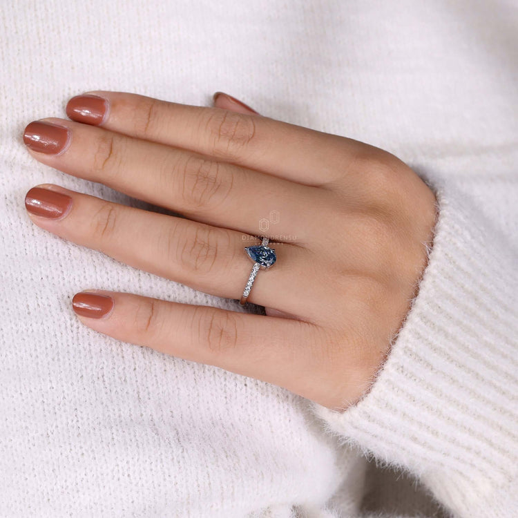 Teardrop diamond ring with a claw prong setting, perfect as a unique engagement ring.
