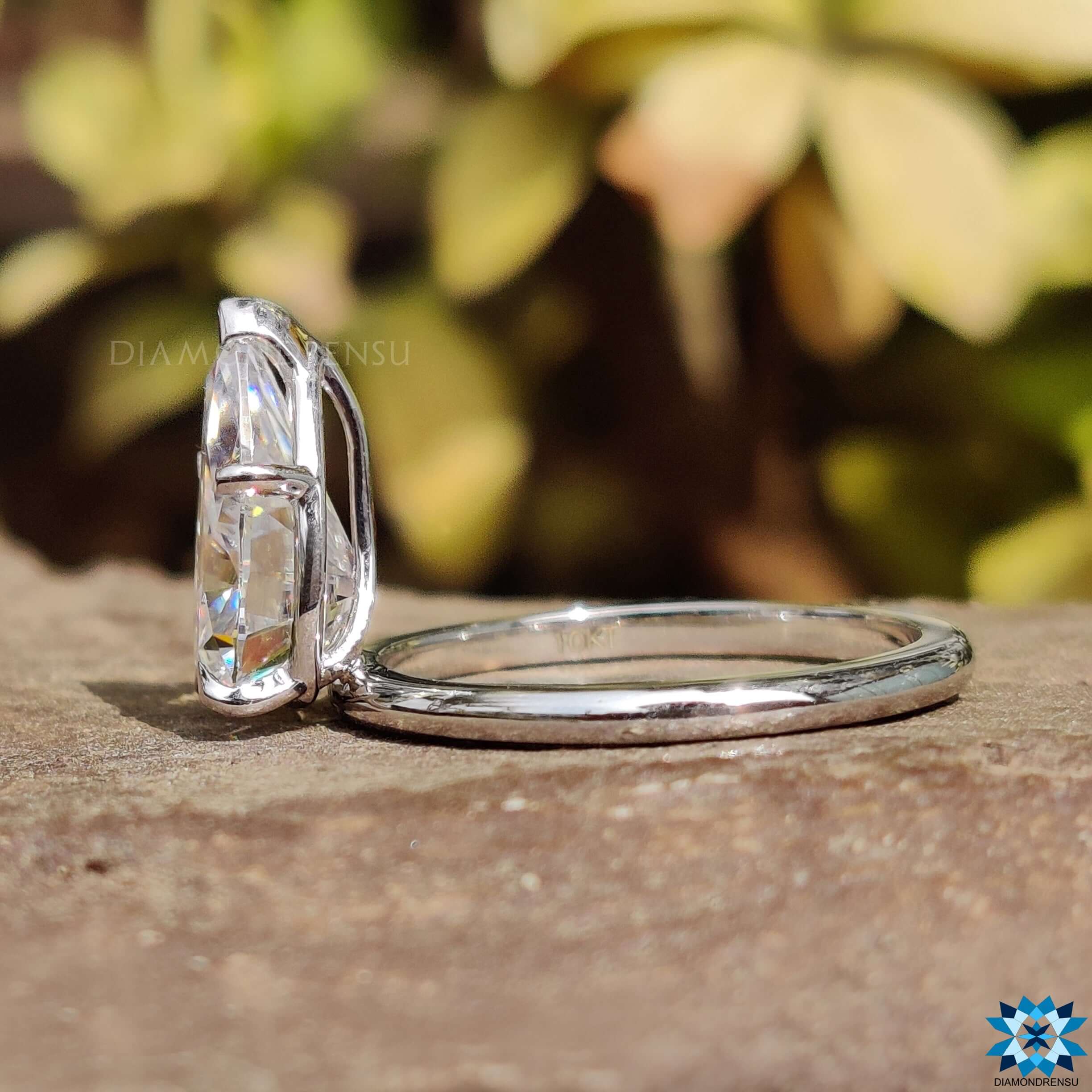 Claw prong setting holding a pear moissanite engagement ring for secure brilliance.