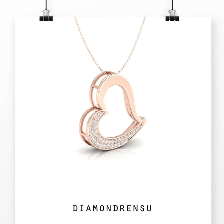 Rose gold pendant with delicate diamond heart centre.
