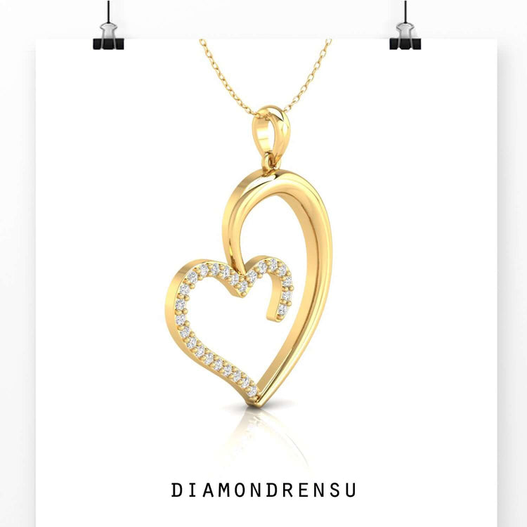 Yellow gold pendant with open heart and diamond touch.
