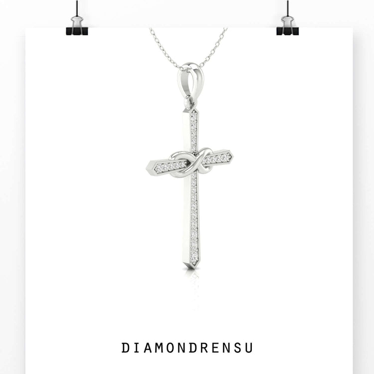 Shared prong setting pendant featuring an infinity cross design.
