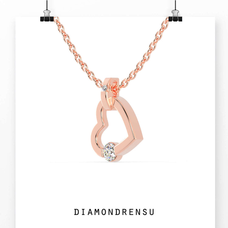 Unique heart pendant featuring prongless tension set diamond.
