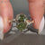 Green centre diamond ring with bypass setting.