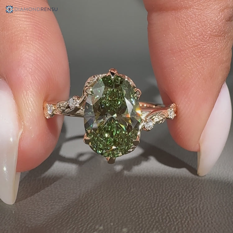 Green centre diamond ring with bypass setting.