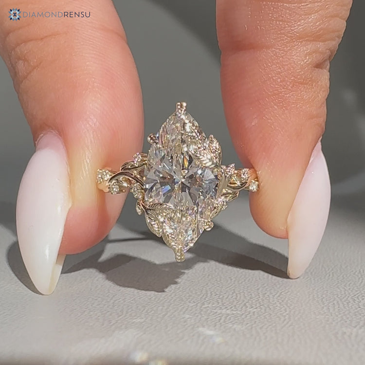 Nature inspired marquise ring with six leaf prong setting.