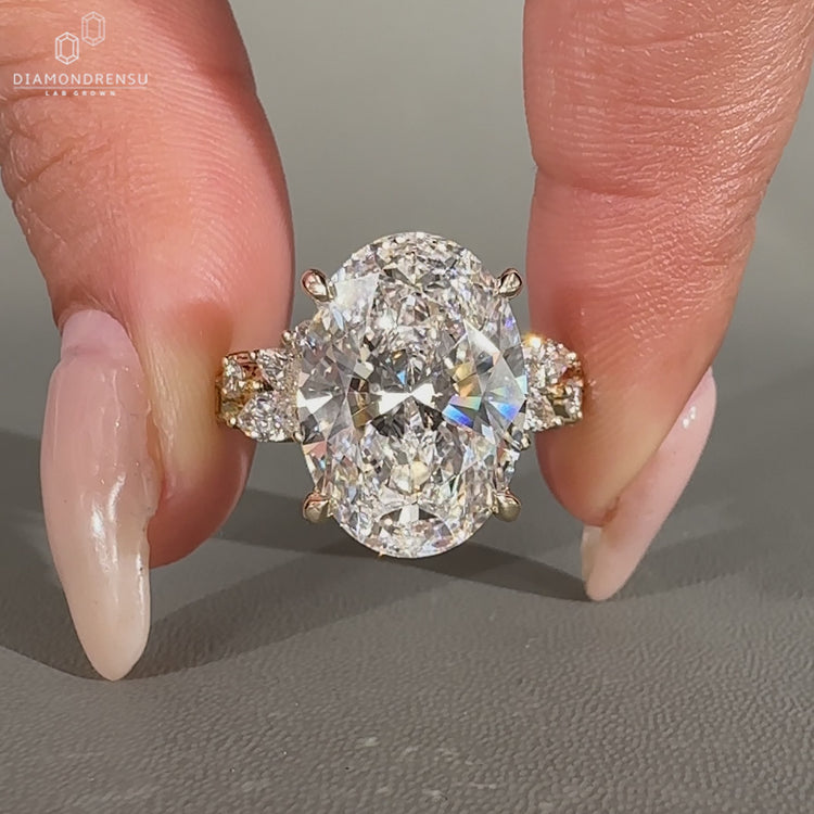 Oval engagement ring with marquise and round side stones.