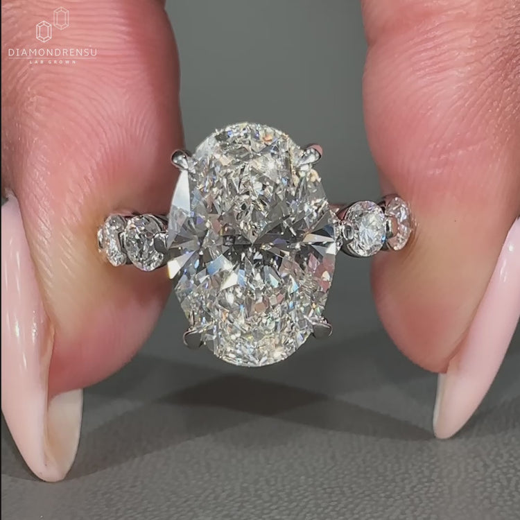 Oval diamond engagement ring designed in white gold.