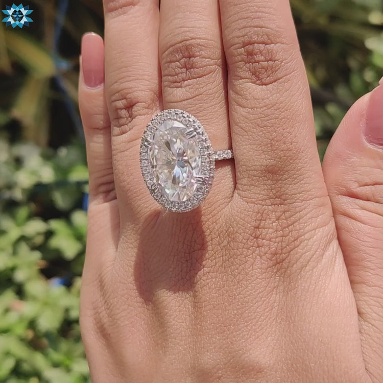 Moissanite engagement ring with elegant side halos.
