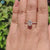 Round cut moissanite ring with pave band.