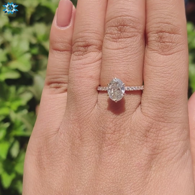 Round cut moissanite ring with pave band.
