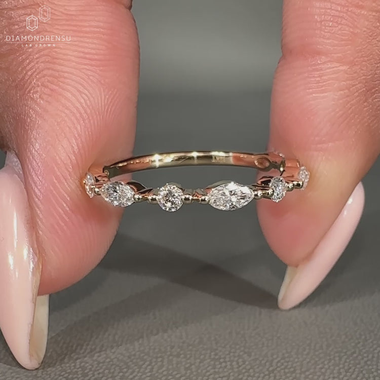Half eternity wedding band featuring marquise and round lab grown diamonds.
