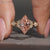 Pink marquise diamond ring with round side stones.