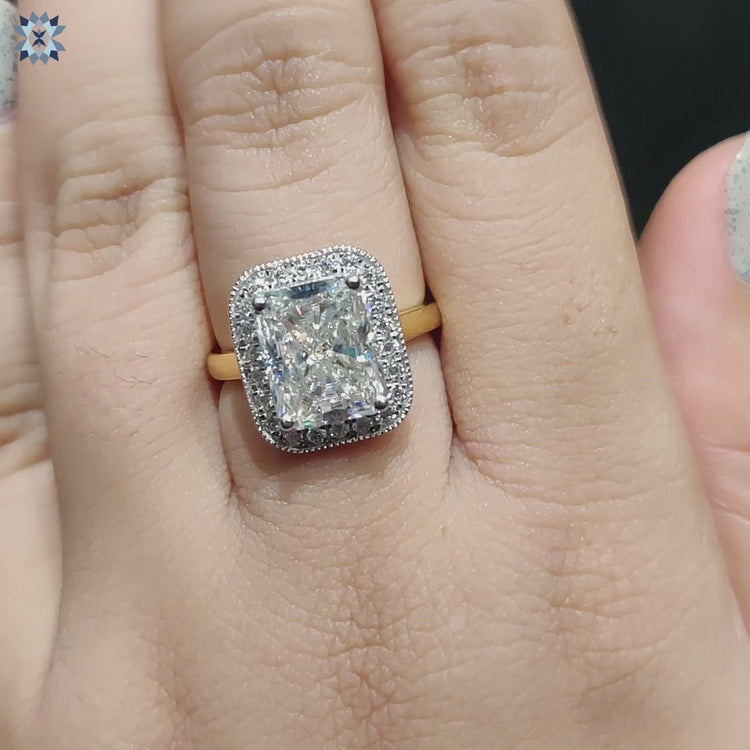 Prong set radiant moissanite ring with milgrain edge in gold.

