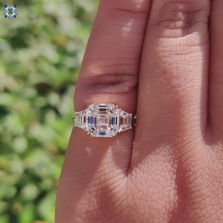 Custom yellow gold engagement ring with sharp-edged three stone design.
