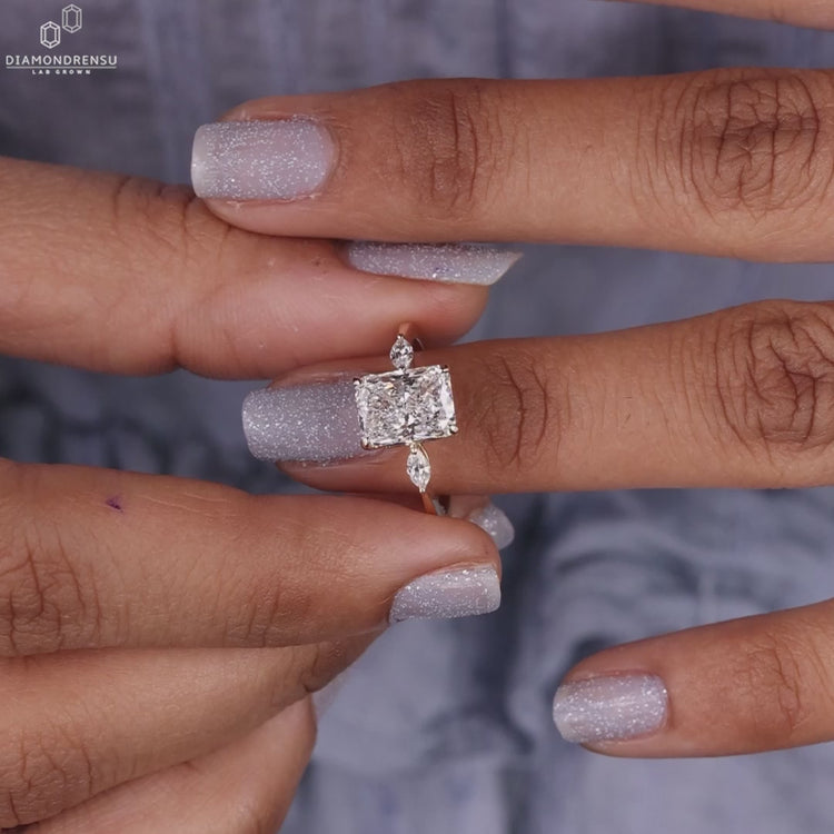 Three stone engagement ring in yellow gold with a marquise cut diamond centrepiece, crafted for unique UK engagements.