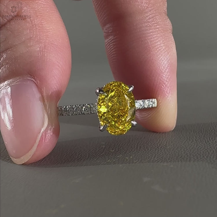 Pave diamond ring with a 4 prong claw setting and oval diamond for a minimalist yet elegant design.
