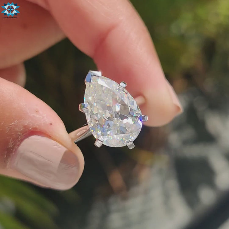 Solitaire engagement ring with pear Rensu cut moissanite and cathedral setting design.
