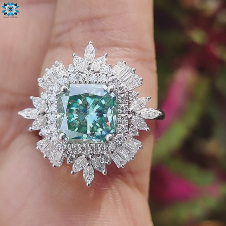 Blue moissanite and round cut side stone ring in white gold.
