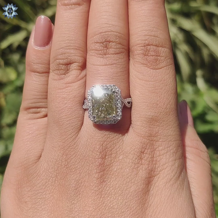Radiant moissanite ring with twisted pave shank.
